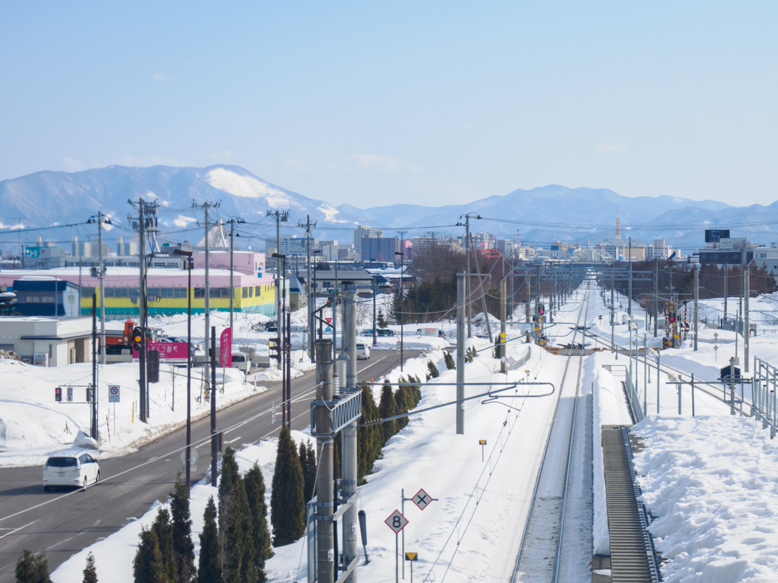 新青森駅の自由通路から見た奥羽本線と夏泊半島の山並み(2025年2月)